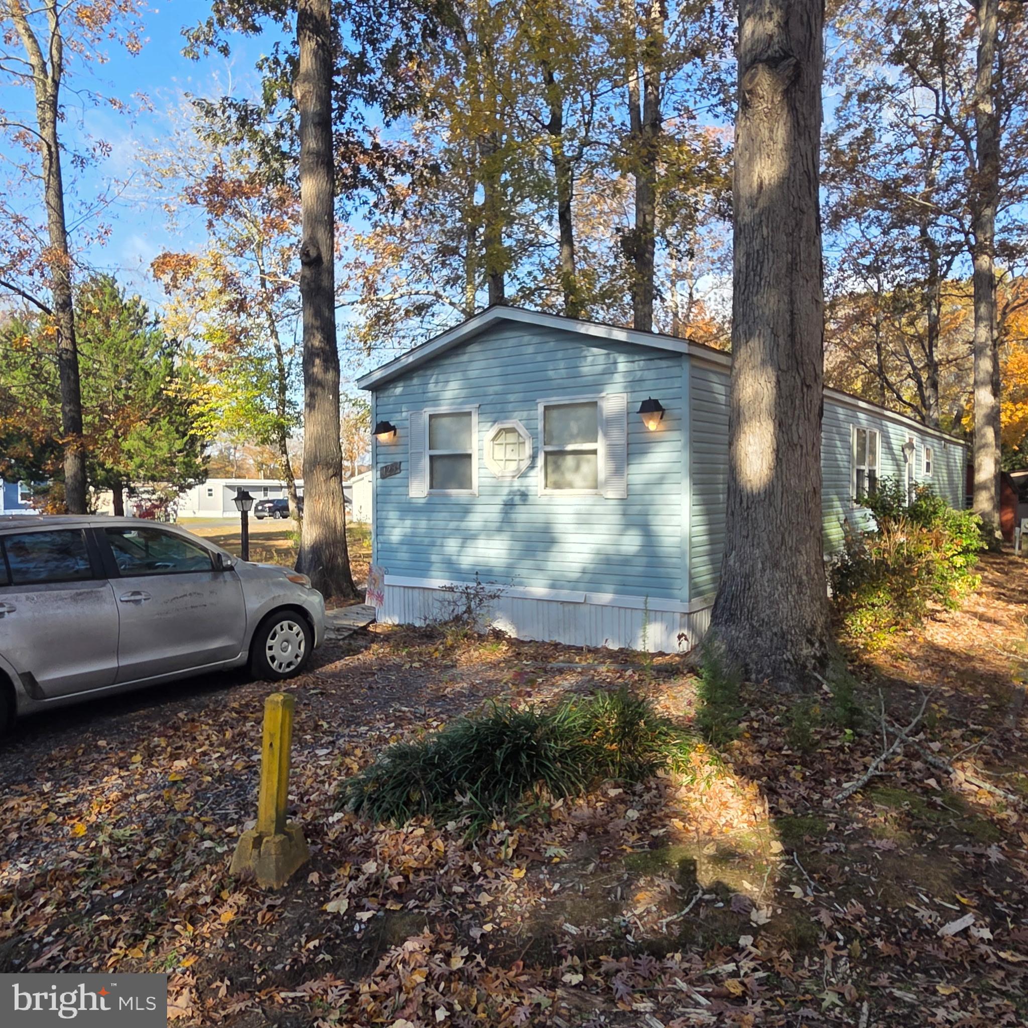 12623 Shell Mill Road, Unit 123 Bishopville, MD 21813 - Photo 14 of 15 a view of a small yard in front of a house with a yard