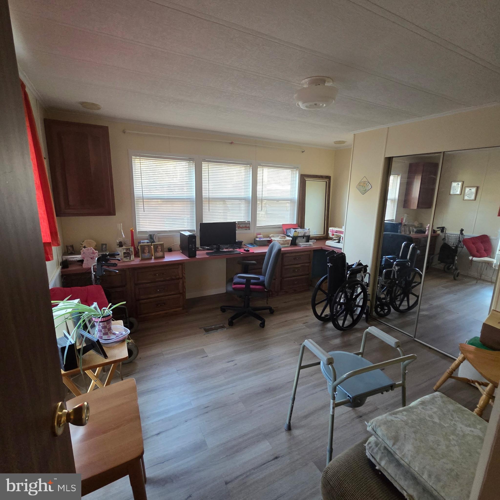 12623 Shell Mill Road, Unit 123 Bishopville, MD 21813 - Photo 10 of 15 a living room with furniture and wooden floor