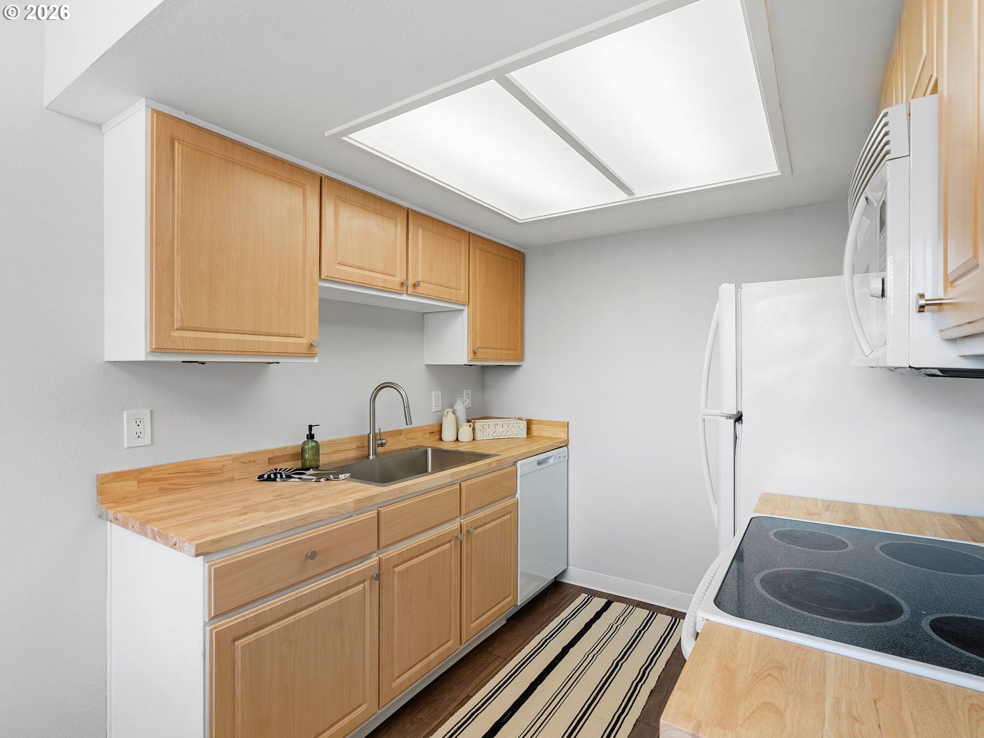 9370 Southwest 146th Terrace, Unit N5 Beaverton, OR 97007 - Photo 11 of 35 a kitchen with sink cabinets and stove