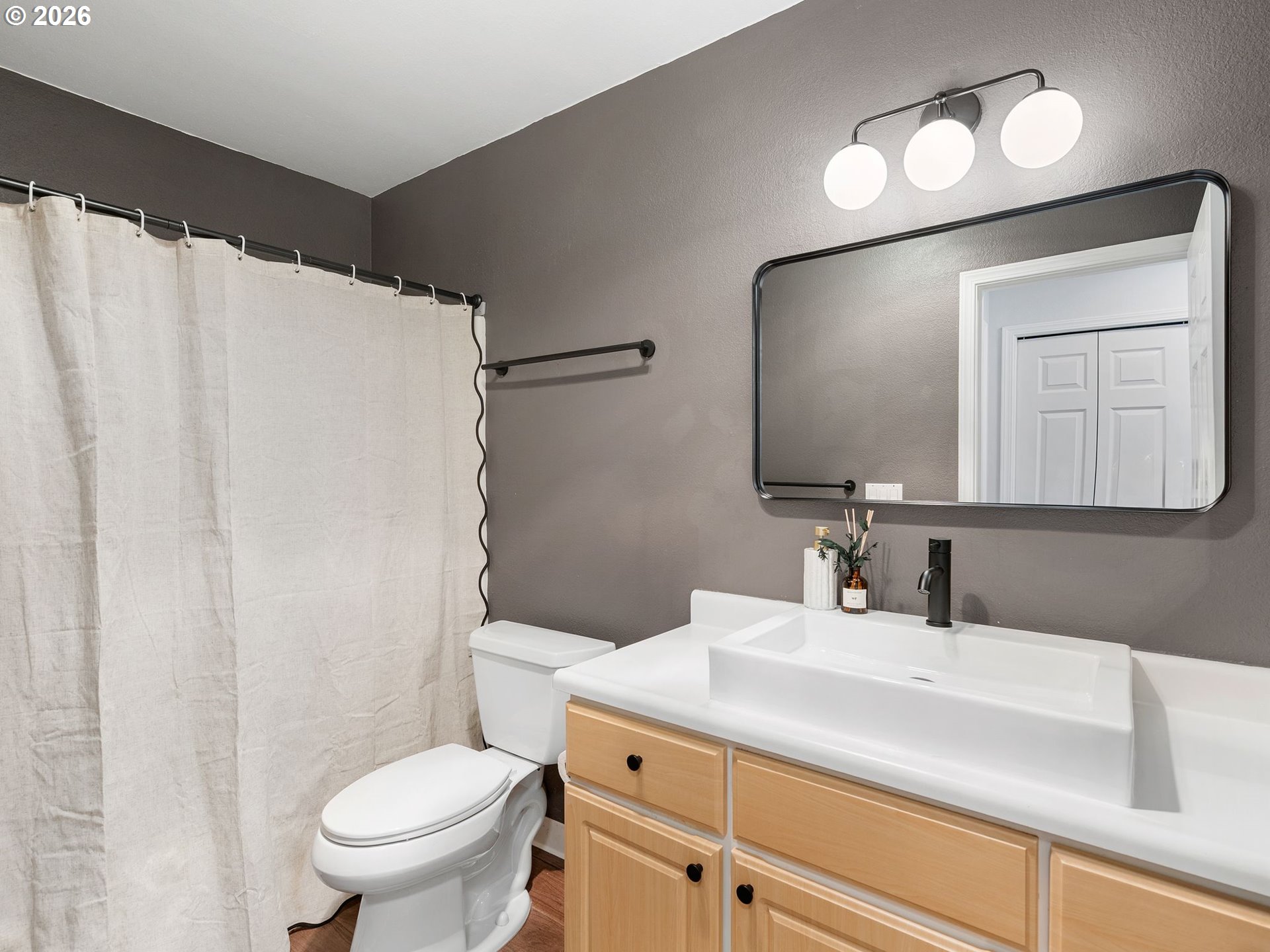 9370 Southwest 146th Terrace, Unit N5 Beaverton, OR 97007 - Photo 14 of 35 a bathroom with a sink vanity mirror and toilet