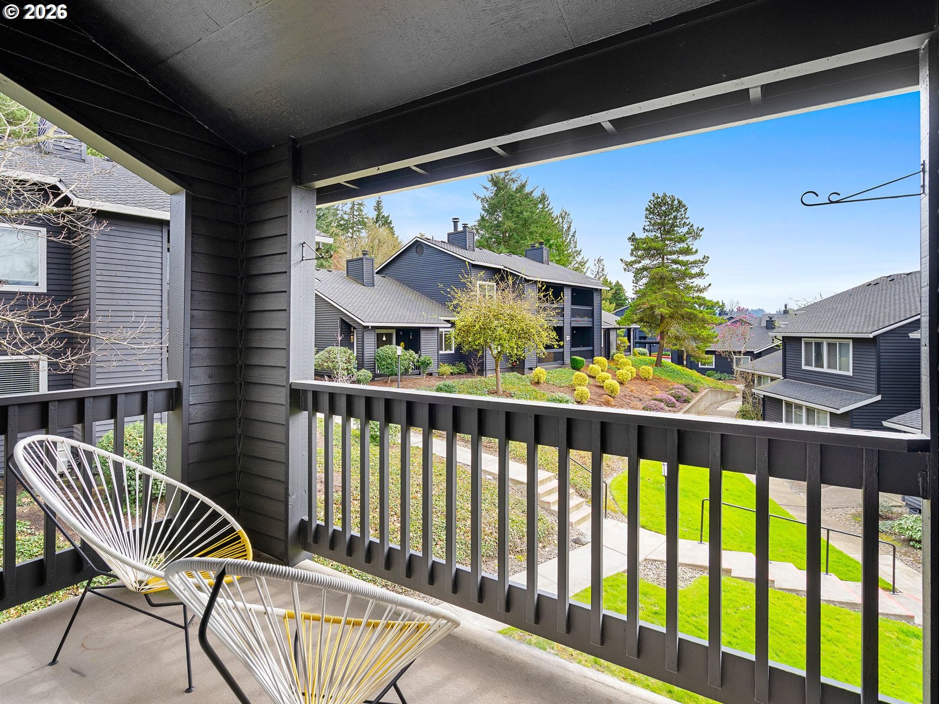 9370 Southwest 146th Terrace, Unit N5 Beaverton, OR 97007 - Photo 20 of 35 a view of a chair and tables in the balcony