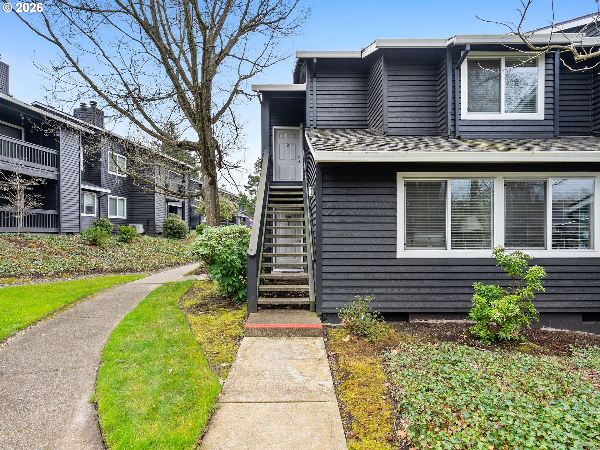 9370 Southwest 146th Terrace, Unit N5 Beaverton, OR 97007 - Photo 2 of 35 a view of a house with a yard
