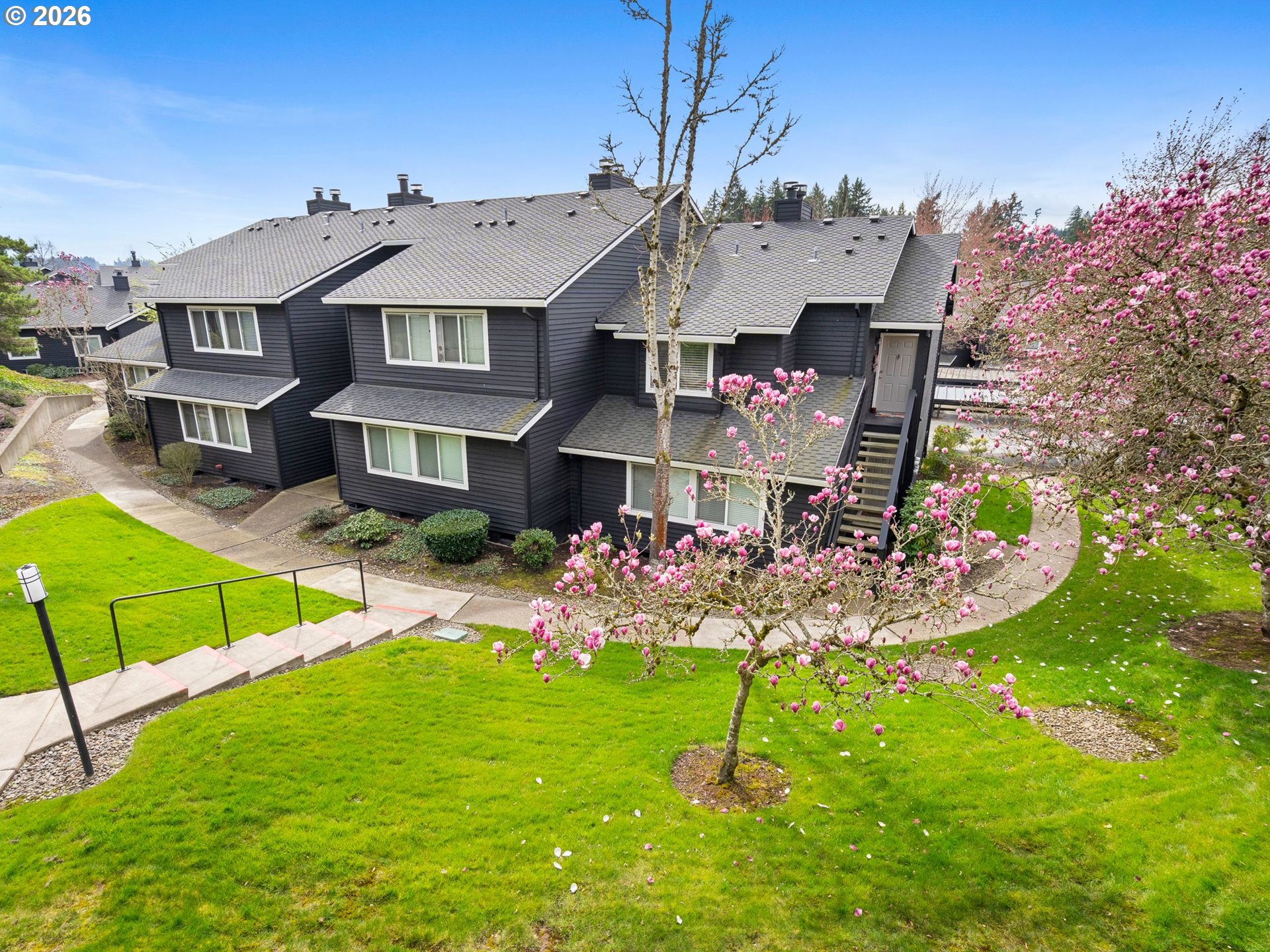 9370 Southwest 146th Terrace, Unit N5 Beaverton, OR 97007 - Photo 24 of 35 a view of a house with a big yard and potted plants