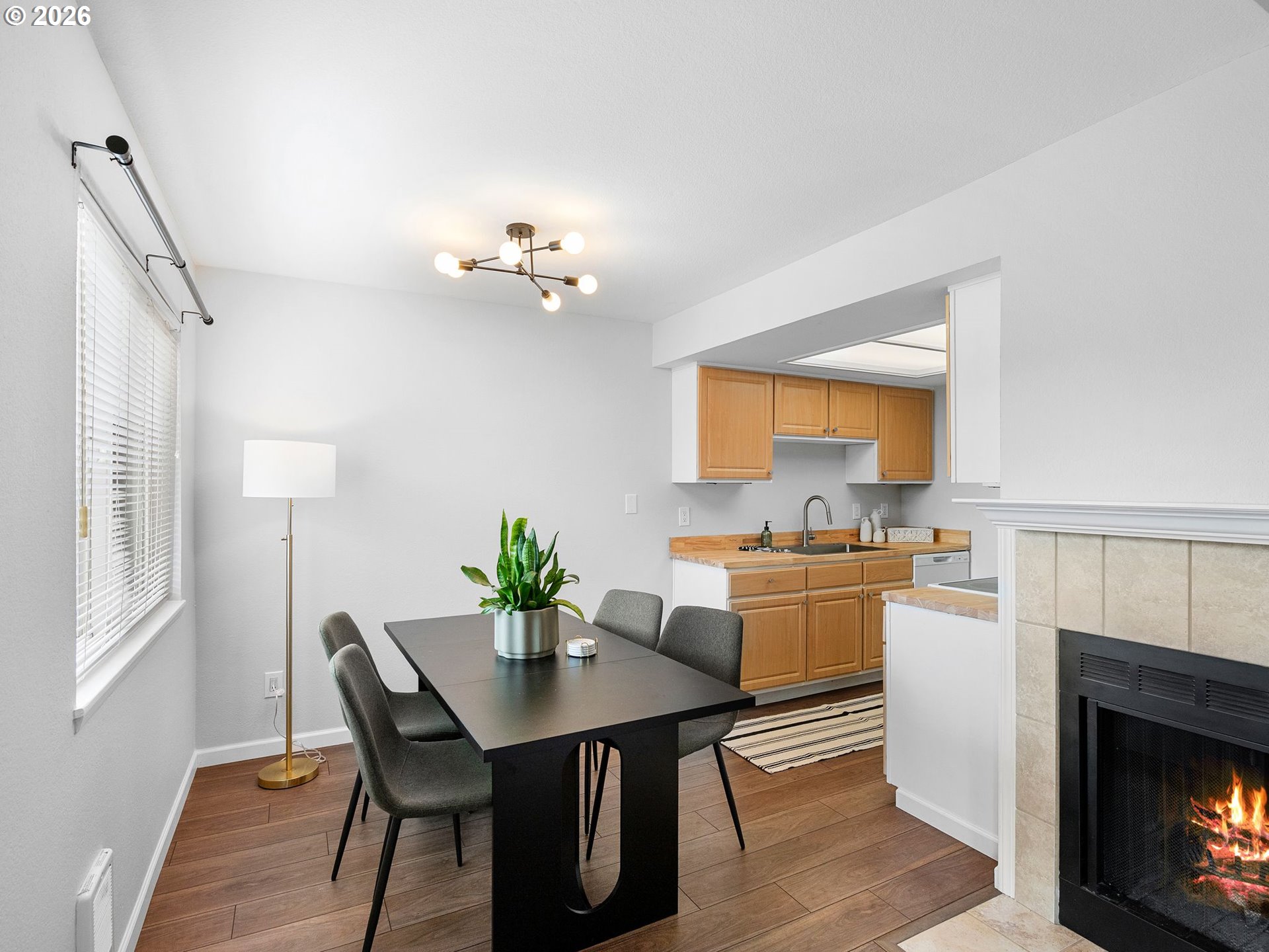 9370 Southwest 146th Terrace, Unit N5 Beaverton, OR 97007 - Photo 7 of 35 a view of a dining room with furniture and a fireplace