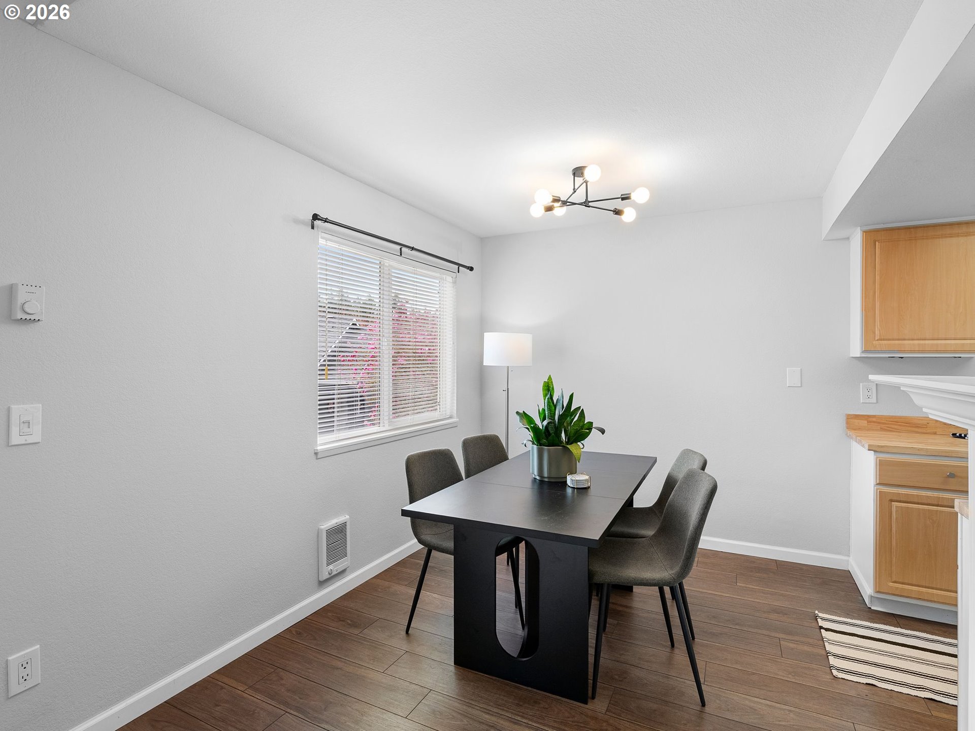 9370 Southwest 146th Terrace, Unit N5 Beaverton, OR 97007 - Photo 8 of 35 a view of a dining room with furniture and wooden floor