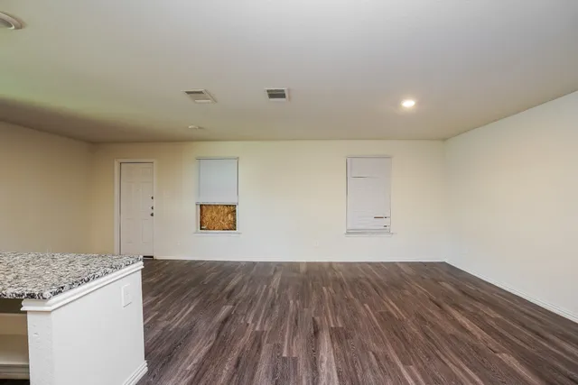 a view of a room with wooden floor