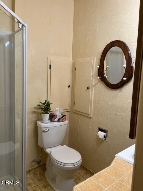 830 South Rice Road Ojai, CA 93023 - Photo 21 of 39 a bathroom with a toilet a sink and a mirror