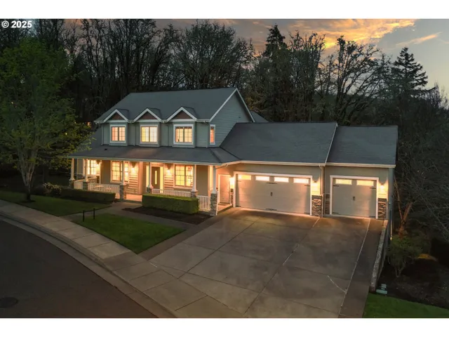 a view of a big house with a big yard and large trees