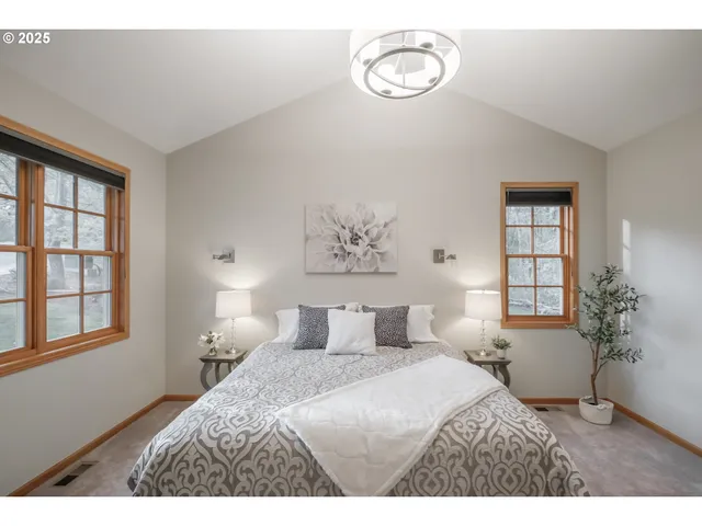 a bedroom with a large bed and a window