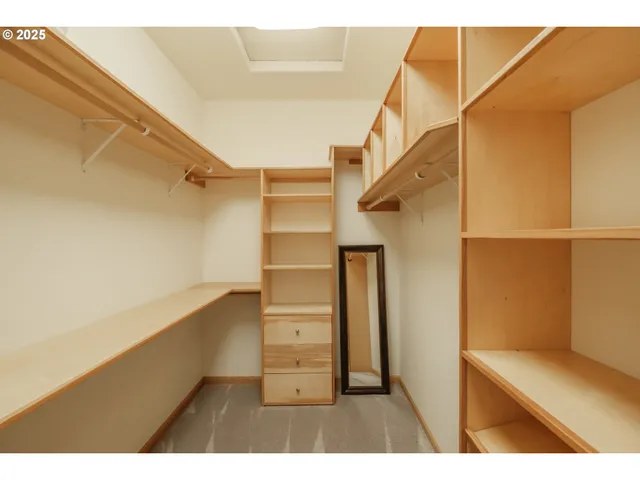 a view of walk in closet with empty racks