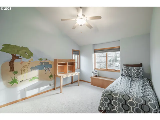 a spacious bedroom with a bed and wooden floor