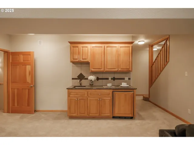 a kitchen with stainless steel appliances a sink stove and cabinets