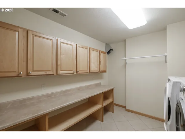 a view of room with cabinets and a wooden floor