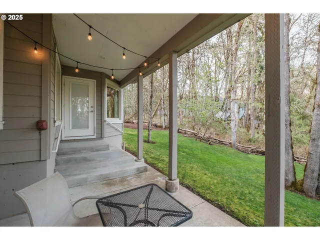 a view of a backyard with large trees