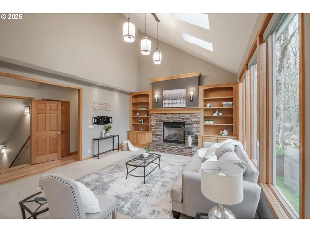 a living room with furniture a fireplace and a large window