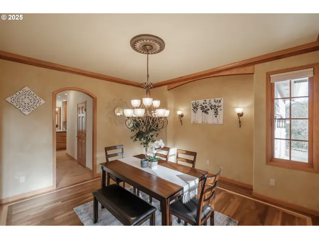 a view of a dining room with furniture and chandelier
