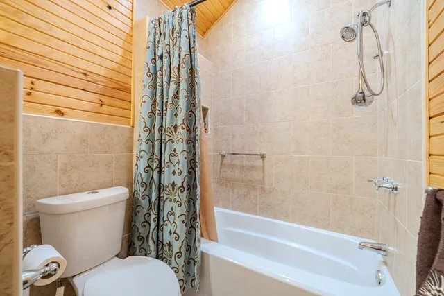 a bathroom with a toilet and shower