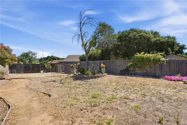 a front view of a house with a garden and deck