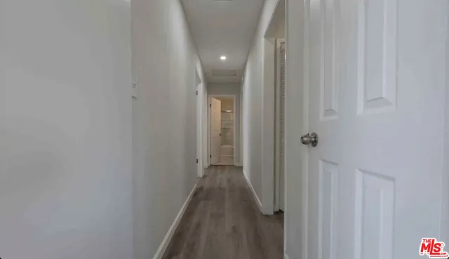 a view of a hallway with wooden floor