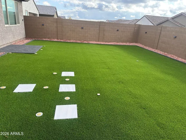 a backyard of a house with lots of green space and plants