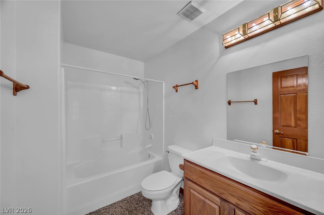 640 North Racetrack Road Henderson, NV 89015 - Photo 38 of 65 A well-appointed bathroom features a practical vanity with an integrated sink and a full-sized bathtub with an overhead shower.