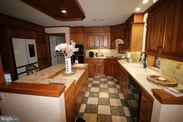 a view of a dining room with furniture a chandelier and wooden floor