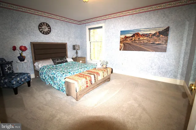 a bedroom with furniture and a flat screen tv