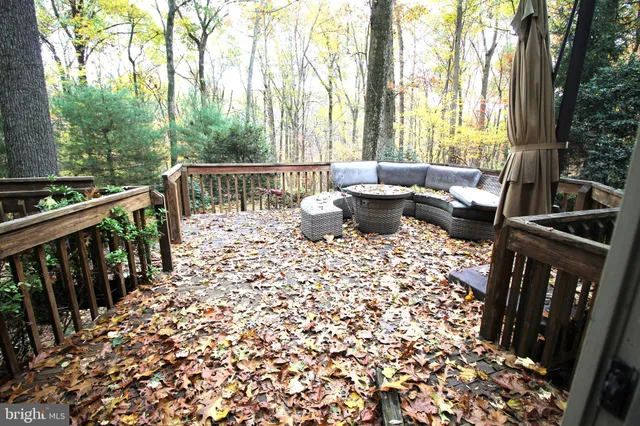 a view of a roof deck with wooden floor and fence