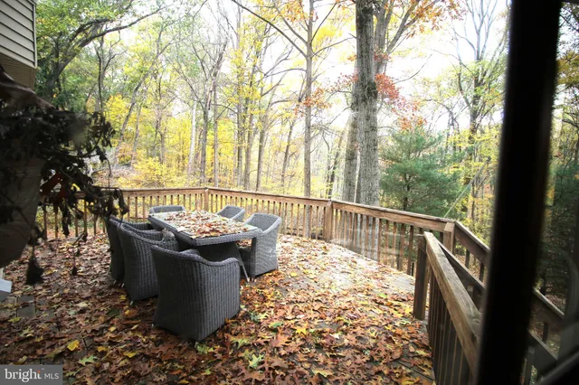 a view of a wooden deck and a backyard