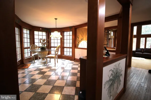 a living room with patio furniture and a floor to ceiling window