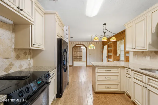 a kitchen with stainless steel appliances granite countertop a stove and a refrigerator