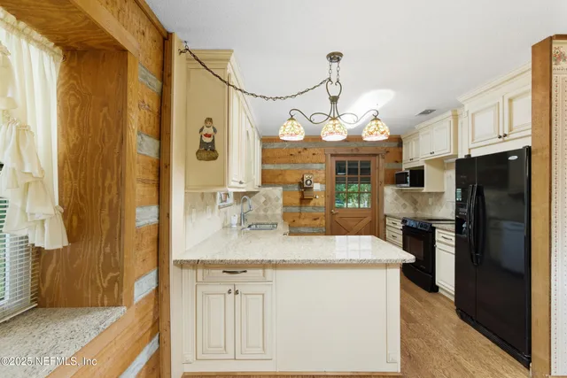 a view of a kitchen cabinets and chandelier