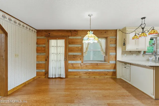 a view of a kitchen with granite countertop sink and dishwasher with wooden floor
