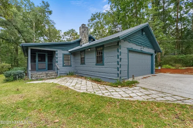 a view of house with backyard space and garden