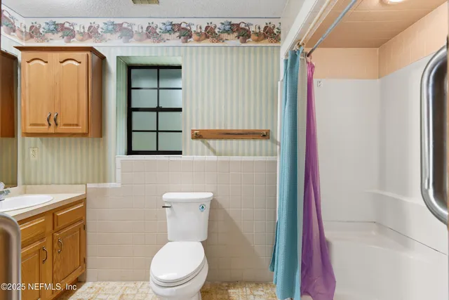 a white toilet sitting next to a bathroom sink