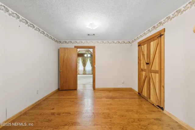 a view of an empty room with glass door