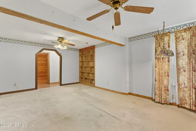 a view of room with large windows