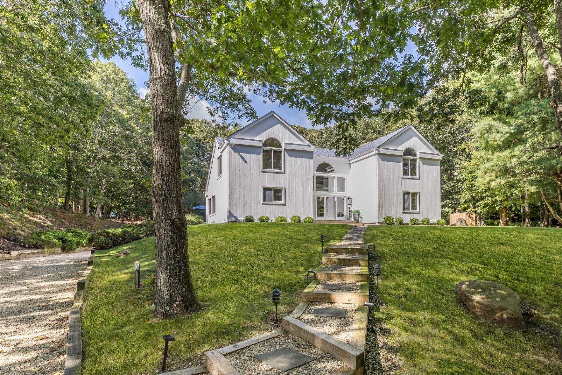 5 Wigwam View Lane East Hampton, NY 11937 - Photo 25 of 28 a front view of a house with a yard