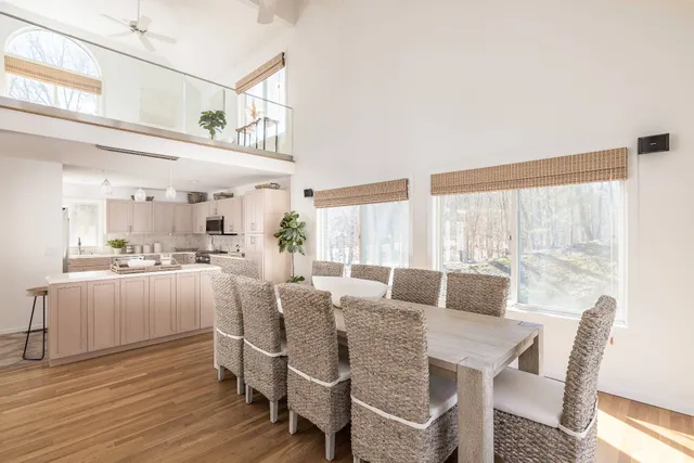 a view of a dining room with furniture window and wooden floor