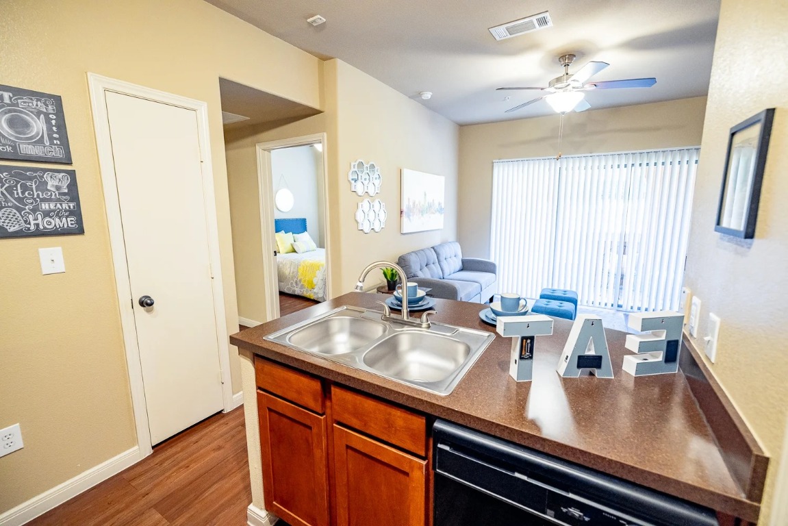 701 Center Ridge Drive, Unit 436 Austin, TX 78753 - Photo 11 of 20 a view of kitchen island with furniture and wooden floor
