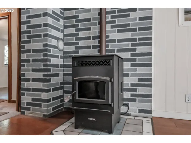 a view of a livingroom with a chair and wooden floor