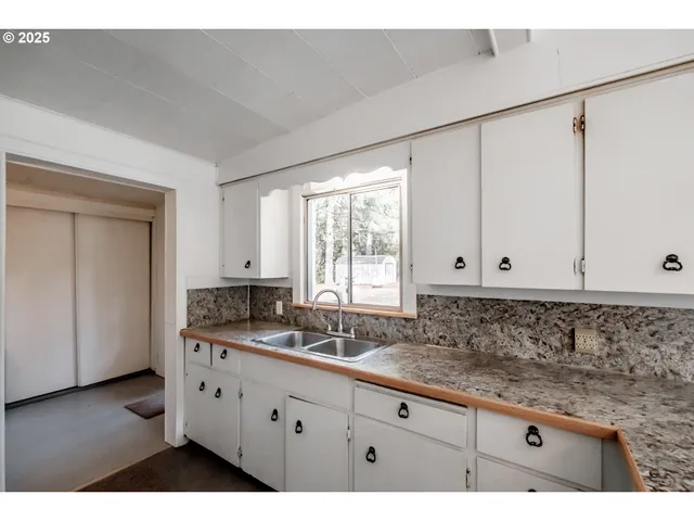 a kitchen with a sink appliances and cabinets