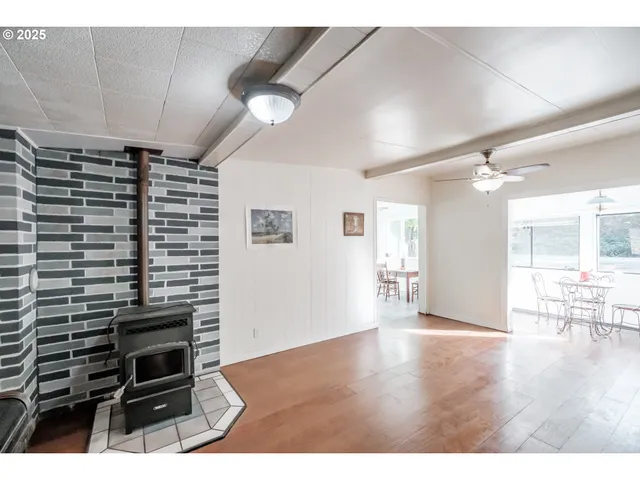 a living room with furniture and a view of kitchen