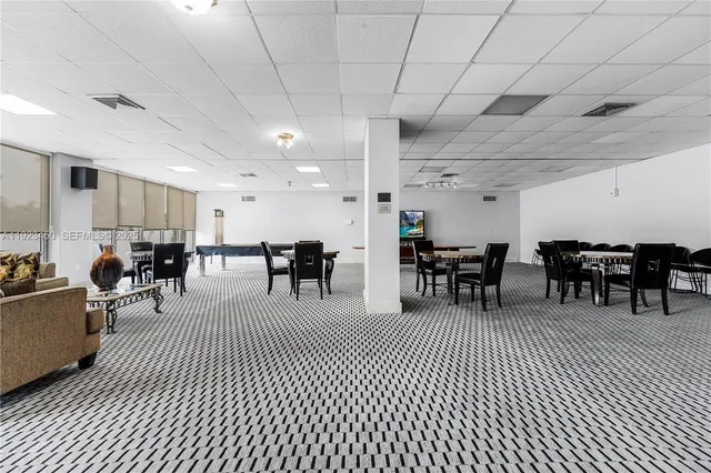 a room with lots of chairs and a projector screen