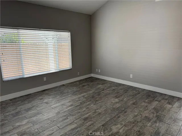 an empty room with wooden floor