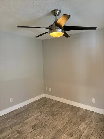 a view of a room with wooden floor and white walls