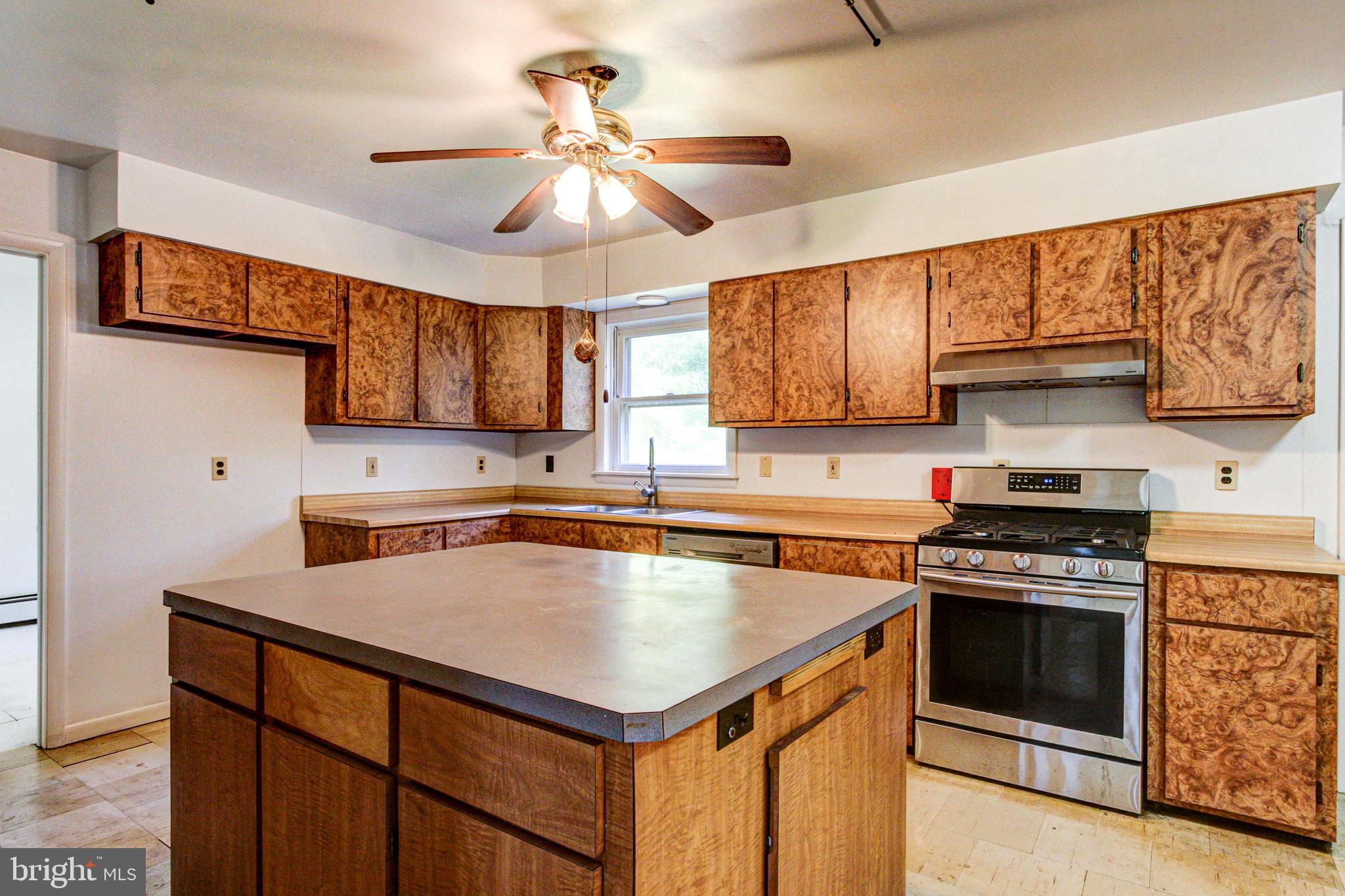 2030 Upper Ridge Road Green Lane, PA 18054 - Photo 12 of 61 a kitchen with stainless steel appliances a stove a sink and cabinets