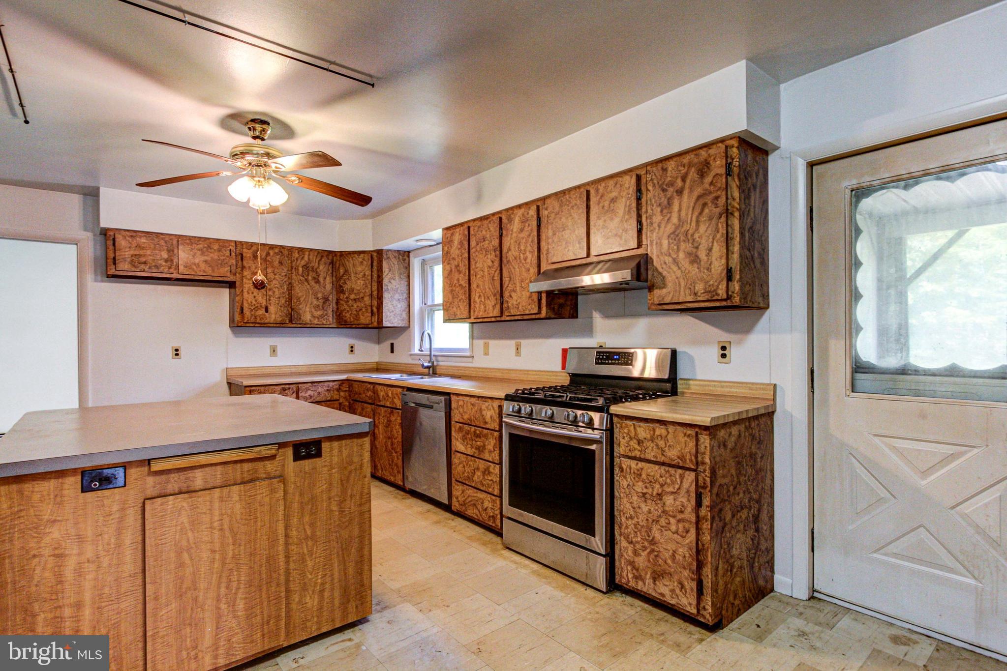 2030 Upper Ridge Road Green Lane, PA 18054 - Photo 14 of 61 a kitchen with stainless steel appliances granite countertop a stove sink and cabinets