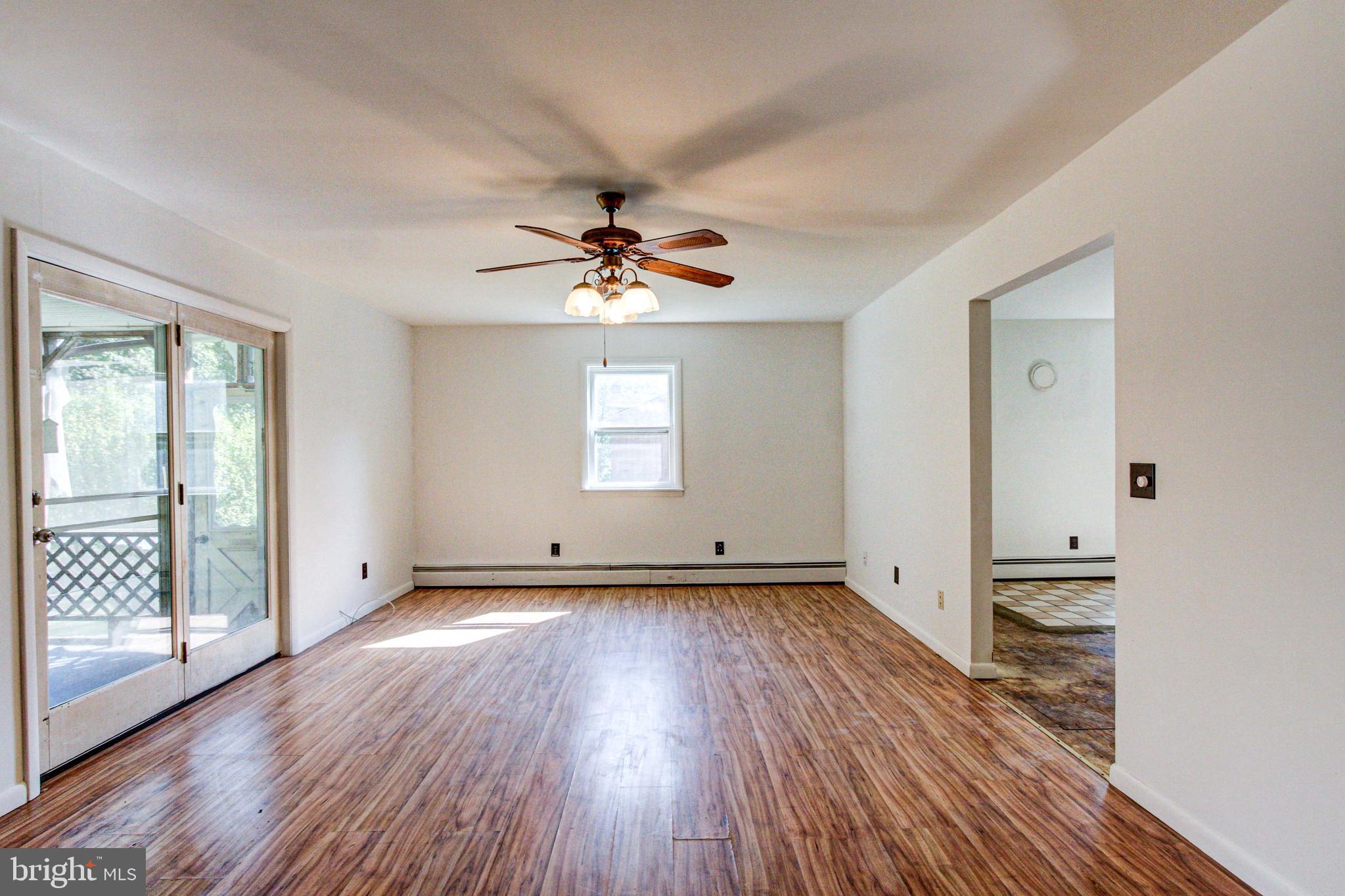 2030 Upper Ridge Road Green Lane, PA 18054 - Photo 16 of 61 a view of an empty room with wooden floor and a window