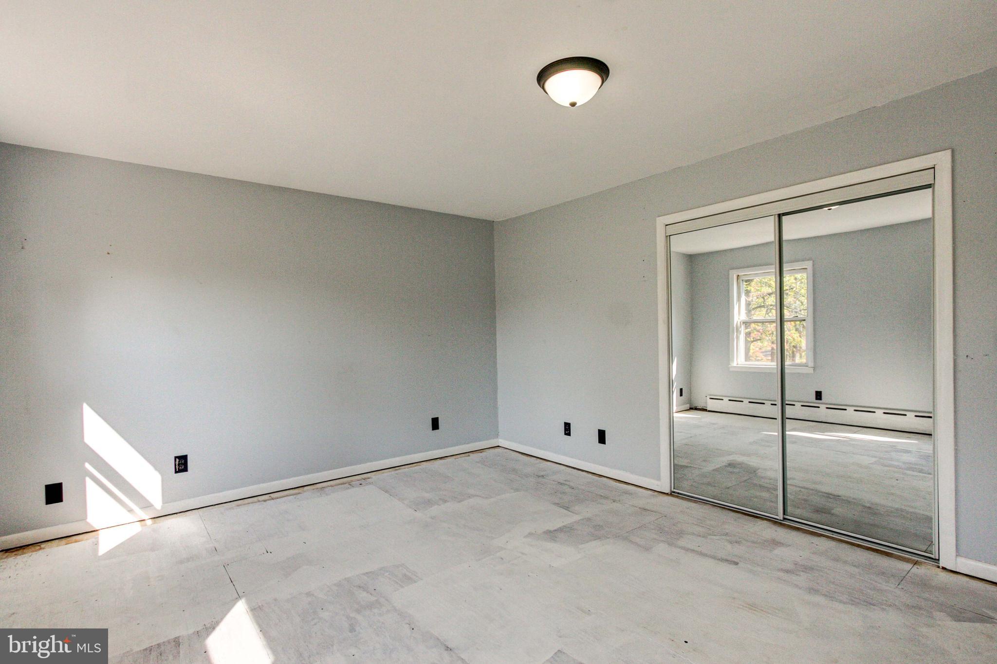 2030 Upper Ridge Road Green Lane, PA 18054 - Photo 30 of 61 an empty room with a fireplace and windows